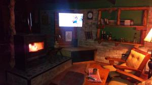 a living room with a fireplace and a couch and chair at La Casona de Gise in La Adela