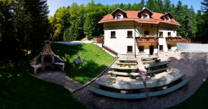 an aerial view of a house with a playground at Green Village Ruševec in Hočko Pohorje