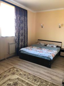 Ένα ή περισσότερα κρεβάτια σε δωμάτιο στο Mini-Hotel Tulpar +17 φωτογραφίες