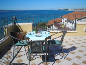 a patio with a table and chairs on a balcony at Casa Del Sol Bed&Breakfast in Sukošan