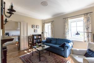 a living room with a blue couch and a table at Landhaus Piber in Piber