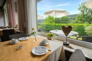 a table in a room with a large window at Pension Himmelreich in Glatt +33 photos