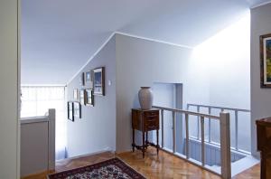 a hallway with a staircase with a vase on a table at Apartments Rafaj in Pula