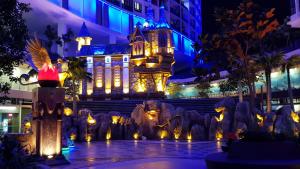 a city lit up at night with a building at Q Suite at i-City in Shah Alam