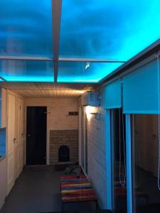 a blue light in a room with a fireplace at Houseboat on the water in Liepāja