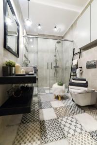 a bathroom with a shower and a toilet and a sink at Tamka Chopin Apartment in Warsaw