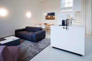 a living room with a couch and a table at Urban Residences Maastricht in Maastricht