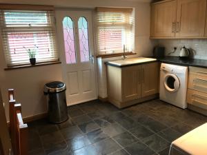 a kitchen with a washing machine and a washer at The Bungalow in Billericay