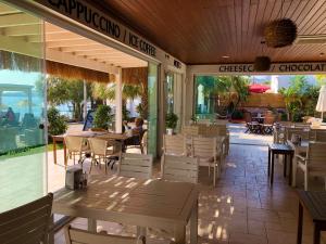 a restaurant with tables and chairs on a patio at Zest Exclusive Hotel & Spa in Ortakent