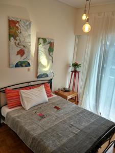a bedroom with a bed with red and white pillows at Archelaou Street Living in Athens