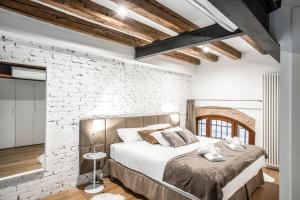 - une chambre avec un mur en briques blanches et un lit dans l'établissement Industrial Loft Venice R&R, à Venise