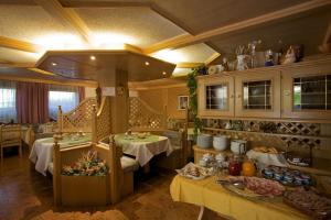 a restaurant with two tables in a room with food at Albergo Bellaria in Carano