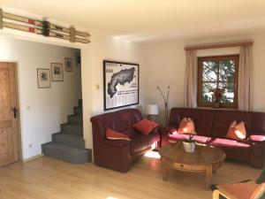 a living room with a couch and a table at Chalet in Maria Alm in ski area with sauna in Maria Alm am Steinernen Meer