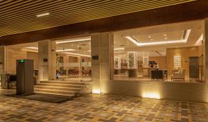 a lobby with a staircase in a building at Lemon Tree Premier, Patna in Patna