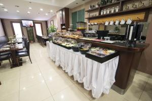 a buffet line in a restaurant with food on it at Cumbali Suite Hotel in Istanbul