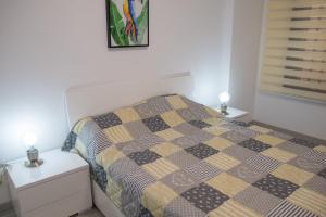 a small bedroom with a bed and two night stands at Viña del Mar II in Playa Fañabe +34 photos