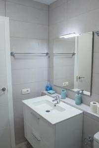 a white bathroom with a sink and a mirror at Viña del Mar II in Playa Fañabe