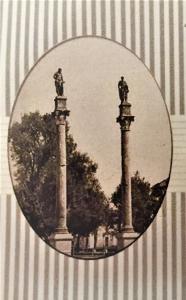 a picture of two columns with statues on them at APARTAMENTOS HÉRCULES SEVILLa in Seville