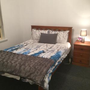 A bed or beds in a room at At HOME on HOLMES