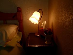 a lamp on a table next to a bed at St Martins Guest House in Dover