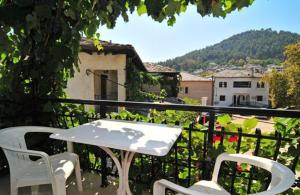 a white table and chairs on a balcony at Chrissafis Hotel in Panagia