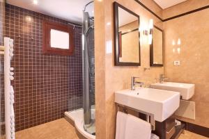 a bathroom with a sink and a toilet and a mirror at Cascade Wellness Resort in Lagos