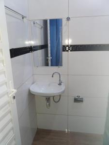 a bathroom with a sink and a mirror at Pousada Aconchego in Mateiros