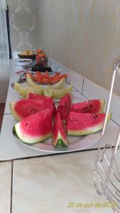 a plate with slices of watermelon and other fruit at Pousada Aconchego in Mateiros