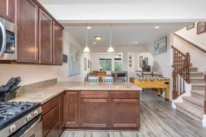 a kitchen with wooden cabinets and a dining room at Glacier Creek in Girdwood