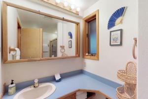 a bathroom with a sink and a mirror at Harmony Haven in McCall +13 photos