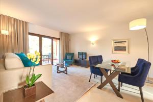 a living room with a table and chairs and a living room at Cascade Wellness Resort in Lagos