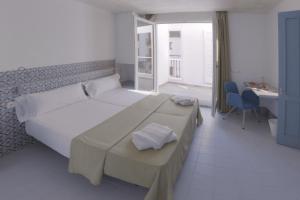 Postel nebo postele na pokoji v ubytování Hostal Gravina