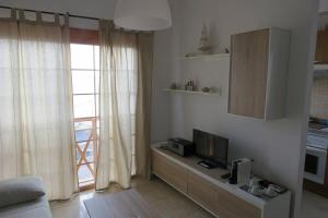 a living room with a television and a window at La Lajita Ocean View 2 in Lajita