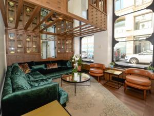 a living room with a green couch and a table at Miapera Hotel and Spa in Istanbul