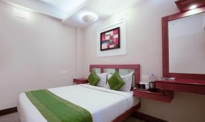 a hotel room with a bed and a projection screen at Treebo The Qasr in Cochin