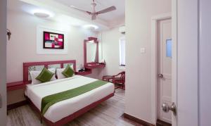 a hotel room with a bed and a door at Treebo The Qasr in Cochin