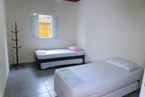a small room with two beds and a window at Chácara Bom Jesus in Aparecida +54 photos