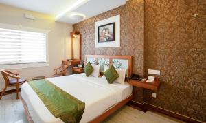 a bedroom with a large bed in a room at Treebo The Qasr in Cochin