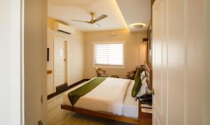 a bedroom with a bed and a ceiling fan at Treebo The Qasr in Cochin
