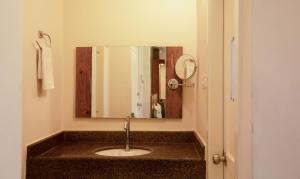 a bathroom with a sink and a mirror at Treebo The Qasr in Cochin