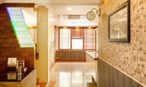 a hallway with a clock on the wall at Treebo The Qasr in Cochin