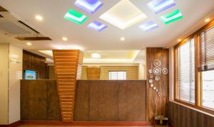 a lobby with a staircase and a ceiling with skylights at Treebo The Qasr in Cochin