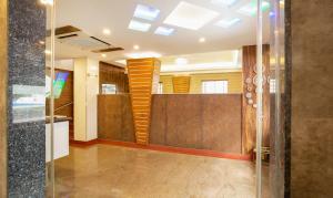 a lobby with a glass door and a staircase at Treebo The Qasr in Cochin