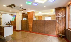 a living room with a staircase and wooden walls at Treebo The Qasr in Cochin