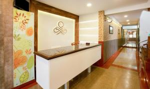 a hallway with a reception counter in a house at Treebo The Qasr in Cochin