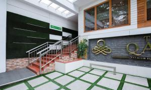 a house with a staircase and a sign on it at Treebo The Qasr in Cochin