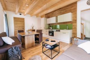 a kitchen and living room with a couch and a table at Ferienwohnungen Orth in Lassing