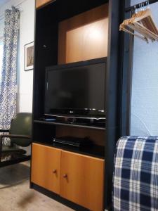 telewizor z płaskim ekranem w drewnianym centrum rozrywki w obiekcie New Diamond XLarge City Center 200 Mbps Speed Wifi Studio w Salonikach