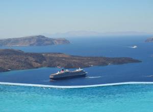 a cruise ship in a large body of water at Suites of the Gods Cave Spa Hotel in Megalokhori