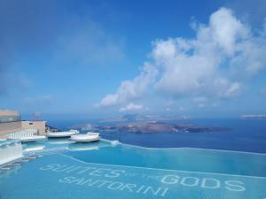 a swimming pool with a view of the ocean at Suites of the Gods Cave Spa Hotel in Megalokhori